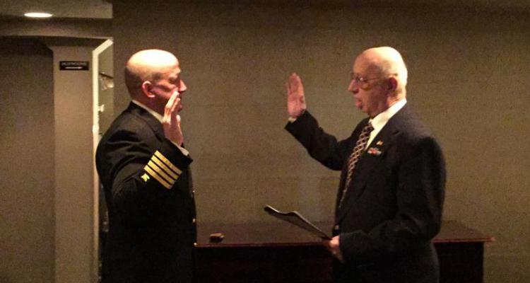 Father gives Oath of Office to son