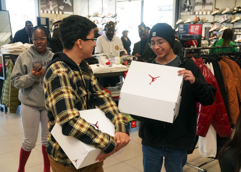 Fred Brock Post 828 H E B place New Shoes on Students during MLK