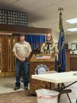 Boy Scout presents flag retirement box