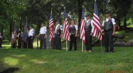 Winona Riders stand flag line for grave rededication