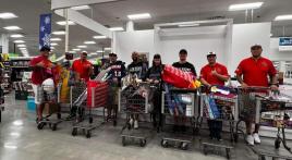 Legion Softball team of Post OK28, Okinawa, Japan, purchase Christmas gifts for children at Amerasian School