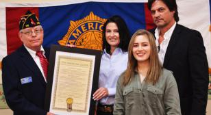 Post 110 presents copy of new post charter to Melberg family 