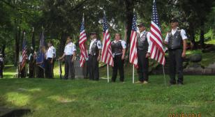 Winona Riders stand flag line for grave rededication